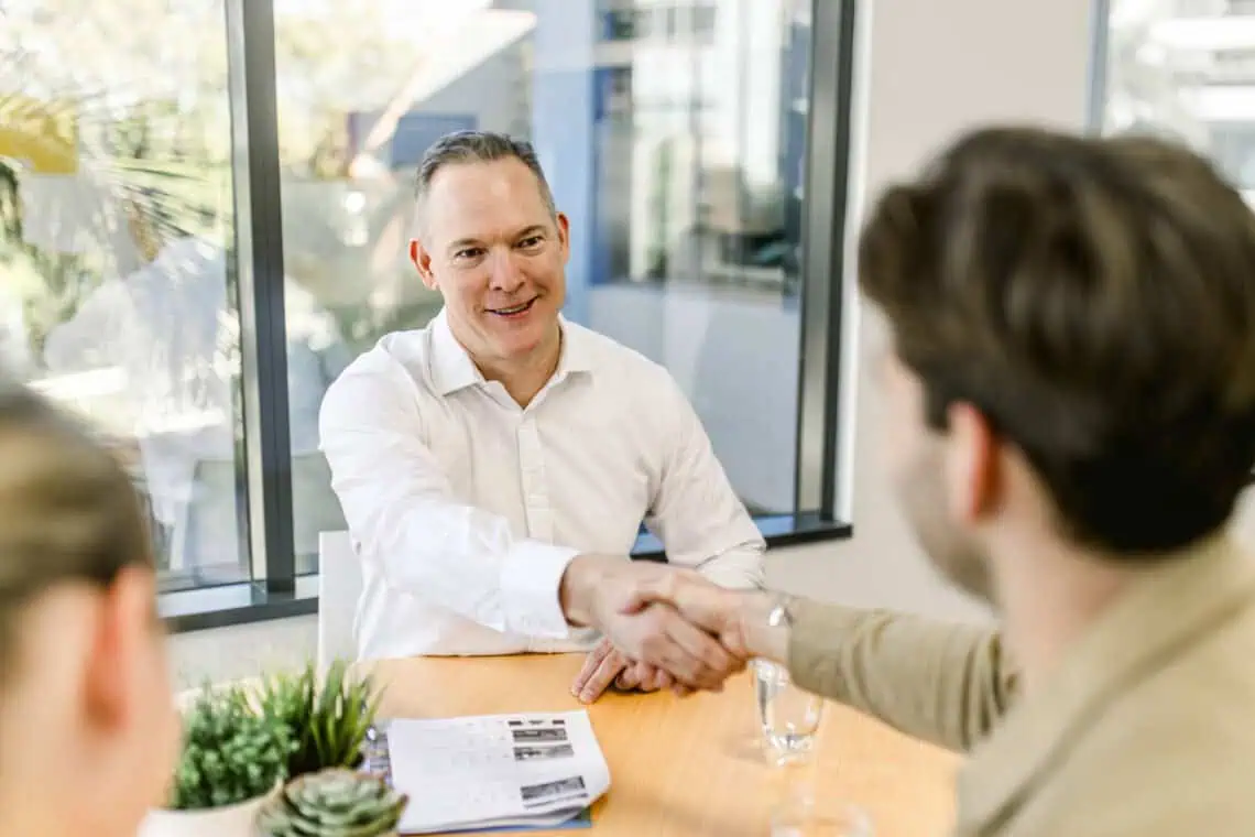 Sam Price of Templeton Property shaking hands with a client who successfully purchased a property through our auction bidding service